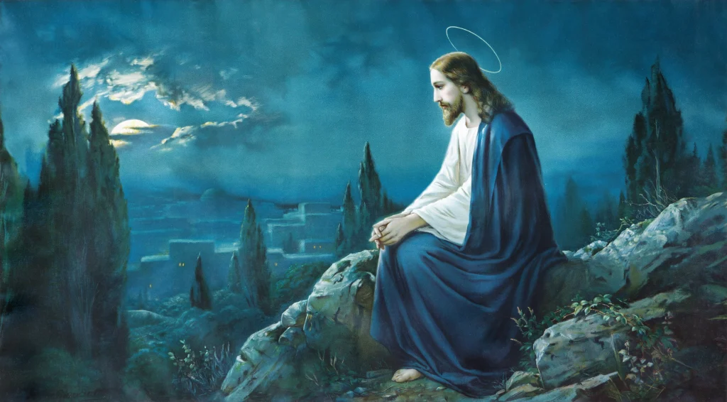 Jesus praying alone on a hillside at night